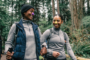 Two friends happily wearing Vegan sunscreen by Nöz while hiking. Nözscreen is safe, reef free, and affordable. Order online and delivered directly to your doorstep. 